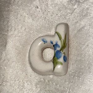 Vintage white ceramic‎ blue floral painted D woman’s lapel pin